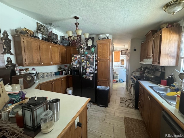 kitchen featuring dishwasher, electric range oven, washer / dryer, black fridge, and light tile patterned flooring