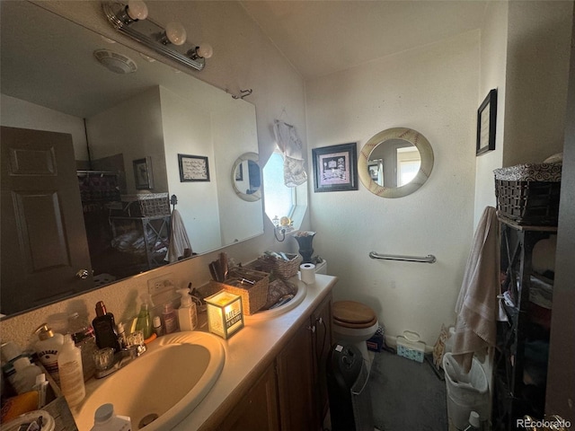 bathroom featuring toilet and vanity