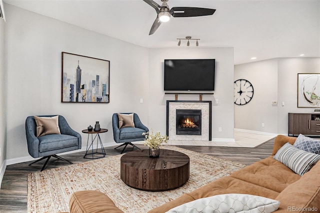 living room with baseboards, a tile fireplace, ceiling fan, wood finished floors, and recessed lighting