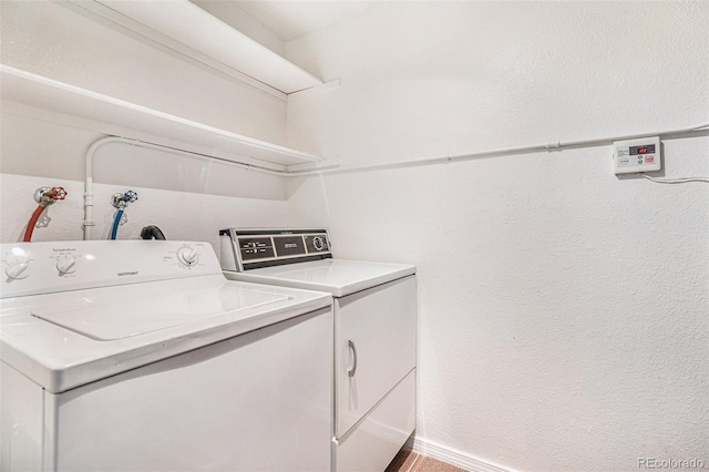 laundry room featuring washing machine and dryer and laundry area