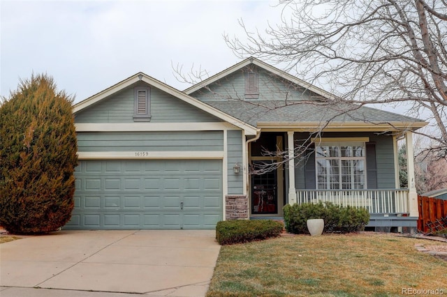 ranch-style home with a porch, a garage, a shingled roof, driveway, and a front yard