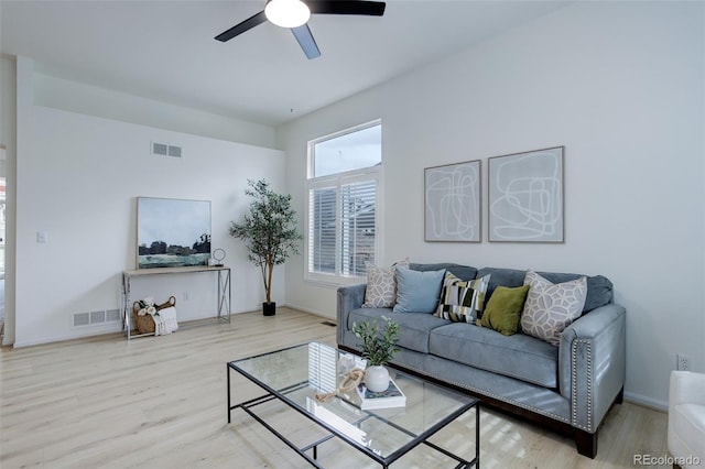 living area with a ceiling fan, baseboards, visible vents, and wood finished floors