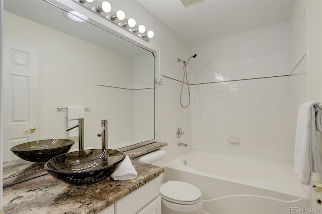 bathroom featuring visible vents, shower / bathing tub combination, vanity, and toilet