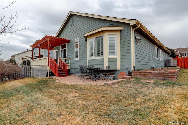 rear view of property featuring a yard, fence, a patio, and a pergola