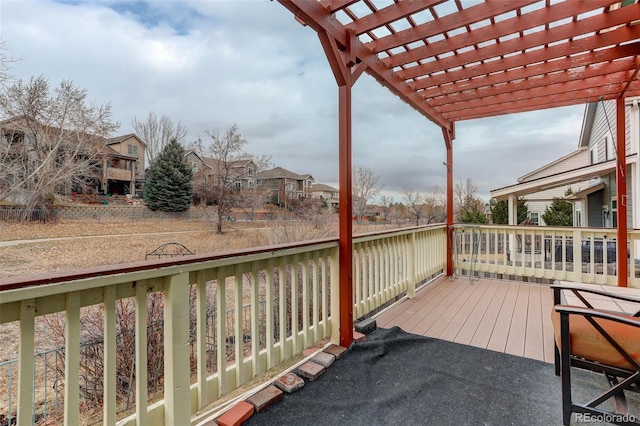 deck featuring a residential view and a pergola