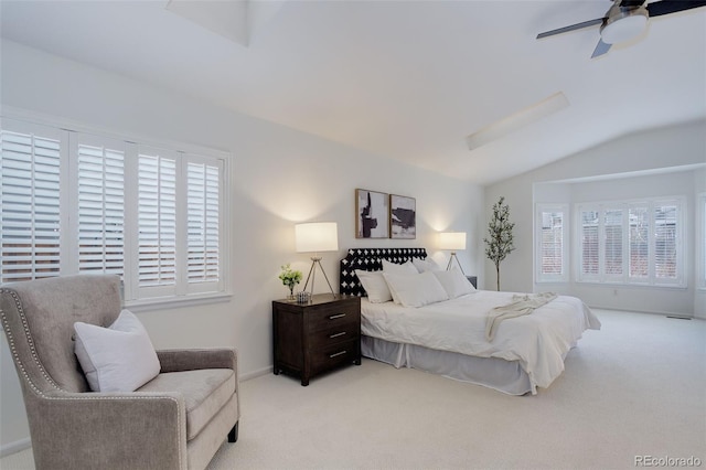 bedroom with carpet, multiple windows, and lofted ceiling