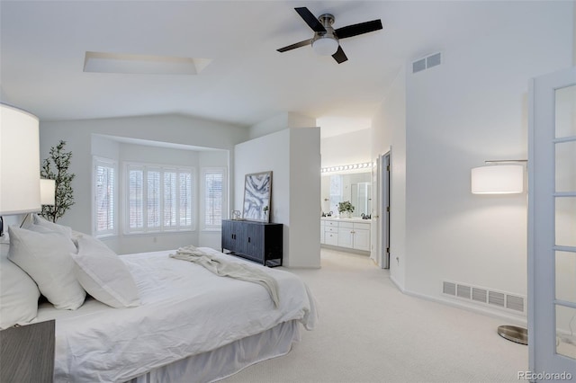 bedroom featuring visible vents, vaulted ceiling, connected bathroom, and light colored carpet