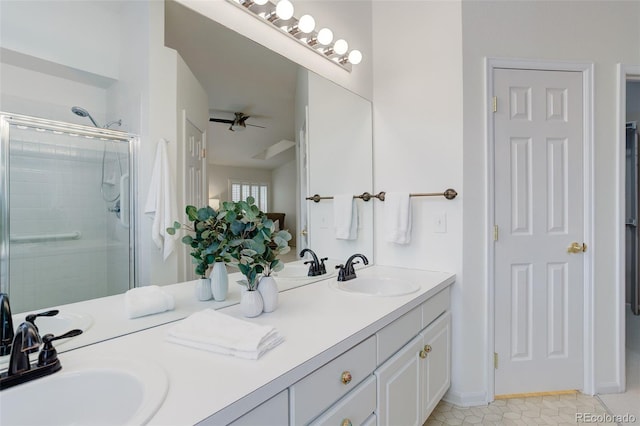 bathroom with double vanity, tile patterned flooring, a sink, and a shower stall