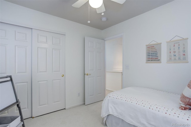 carpeted bedroom featuring a closet and a ceiling fan