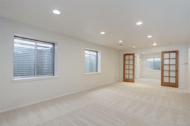 unfurnished room with baseboards, recessed lighting, and light colored carpet