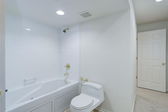 bathroom featuring baseboards, visible vents, a textured wall, toilet, and shower / bathing tub combination