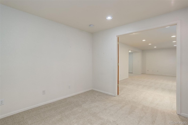 empty room featuring carpet, baseboards, and recessed lighting