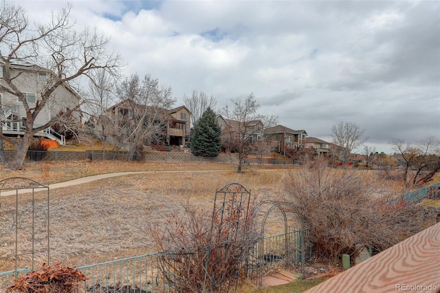 view of yard with a residential view and fence