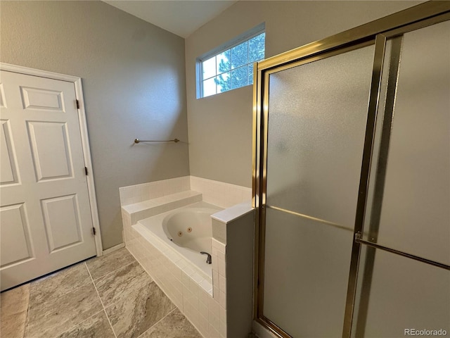 bathroom featuring a jetted tub and a stall shower