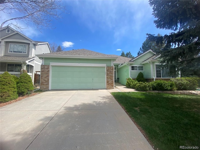 view of front of house featuring brick siding, driveway, and a garage