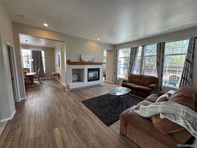 living room featuring baseboards, a wealth of natural light, and wood finished floors