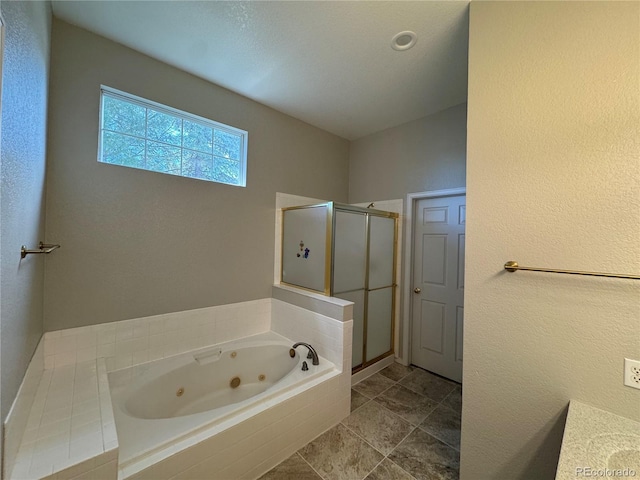 bathroom featuring a jetted tub and a stall shower
