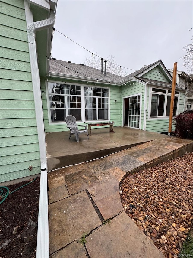 back of house with a patio