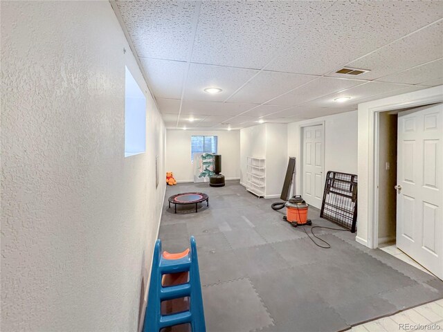 9806 Hooker Ct, Westminster, CO 80031 - basement featuring a drop ceiling, baseboards, and a textured wall