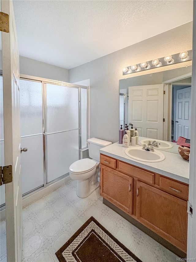 9806 Hooker Ct, Westminster, CO 80031 - full bath with tile patterned floors, a stall shower, vanity, and toilet