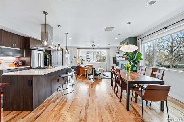 dining room with a ceiling fan, visible vents, recessed lighting, and light wood finished floors