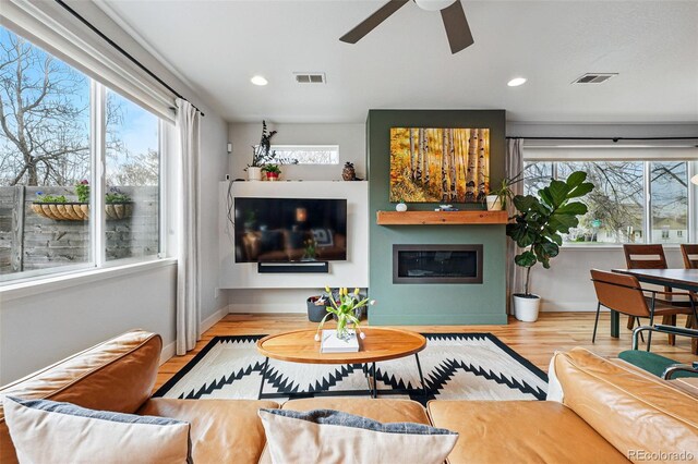 living area featuring visible vents, recessed lighting, ceiling fan, and wood finished floors