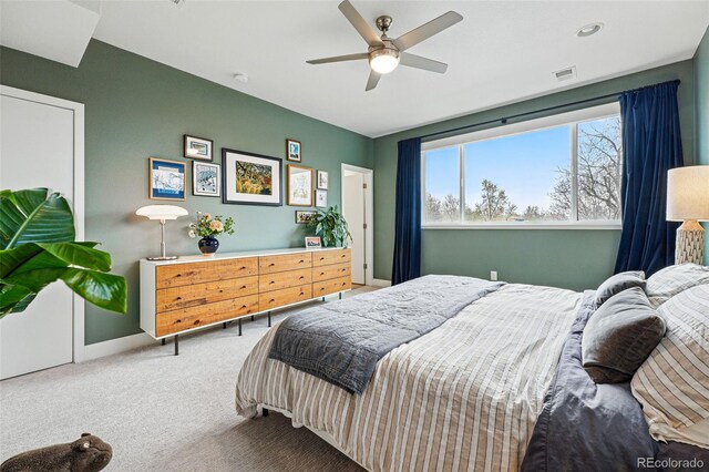 bedroom with carpet floors, baseboards, ceiling fan, and visible vents