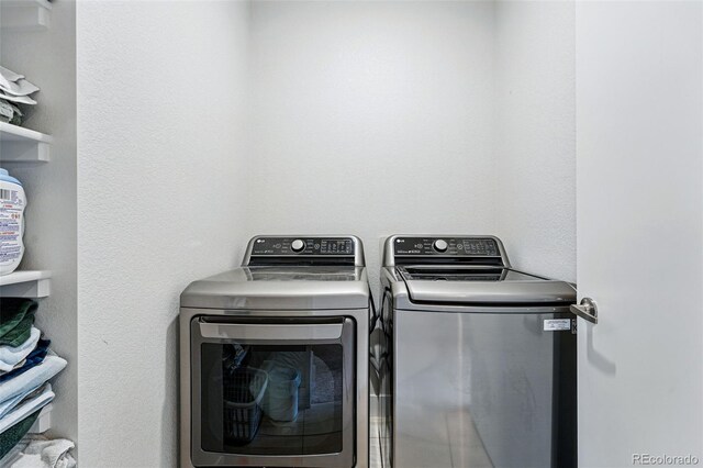 laundry room featuring separate washer and dryer and laundry area