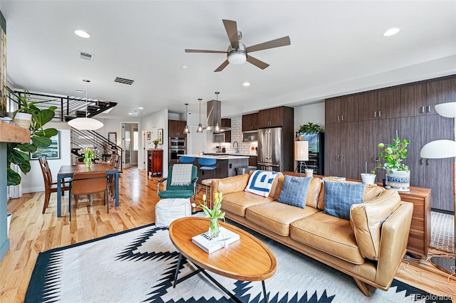 3201 W 25th Ave, Denver, CO 80211 - living area featuring ceiling fan, light wood-type flooring, recessed lighting, and stairway