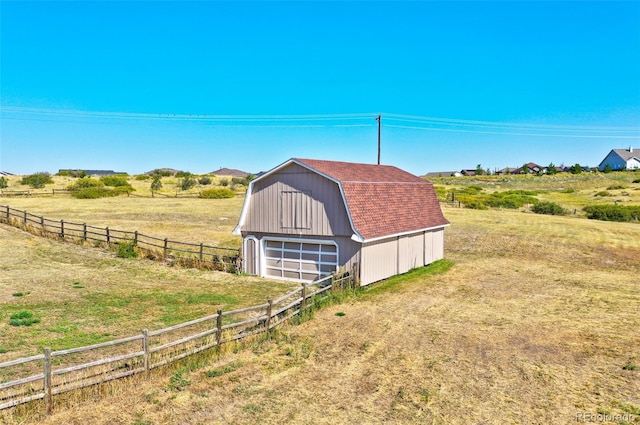 view of outbuilding with a yard and a rural view