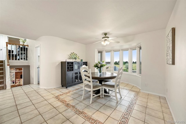 dining space featuring light tile patterned flooring and ceiling fan