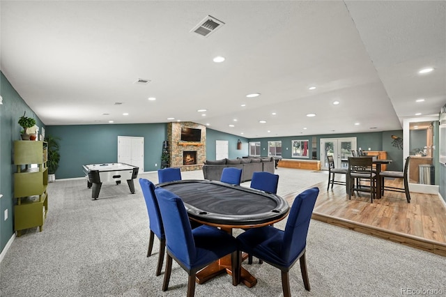 dining space featuring a fireplace and light hardwood / wood-style floors