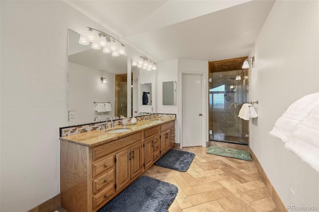 bathroom featuring vanity and a shower with door