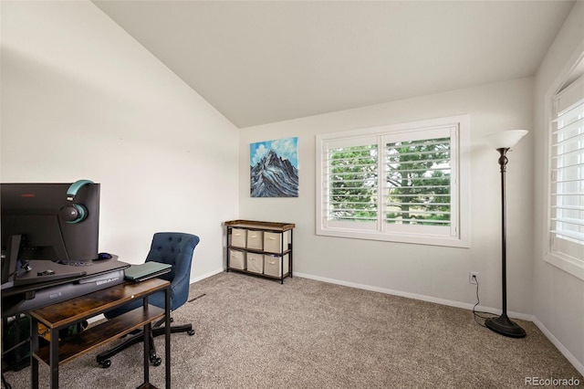 carpeted home office featuring lofted ceiling