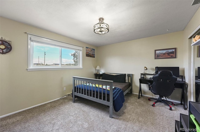 carpeted bedroom with a textured ceiling