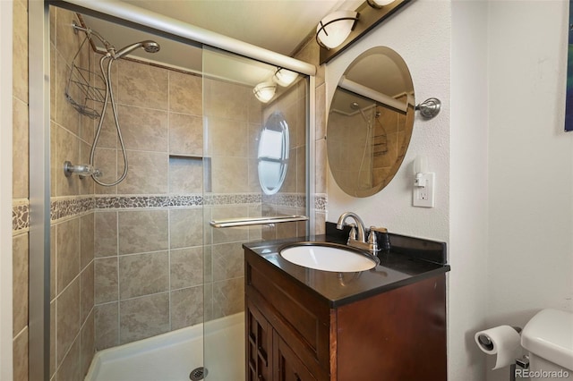 bathroom with vanity, toilet, and walk in shower