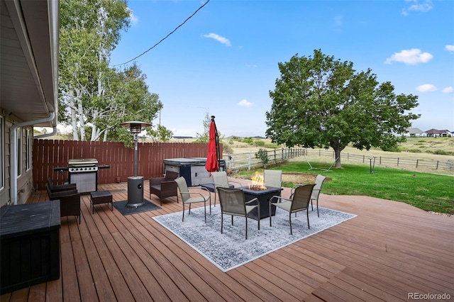 deck featuring an outdoor fire pit and a lawn