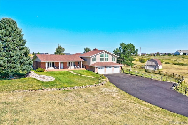 view of front of house featuring a garage and a front yard