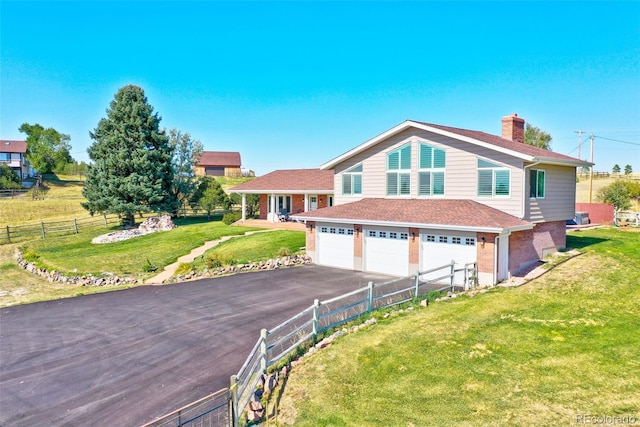 view of front of house featuring a garage and a front yard