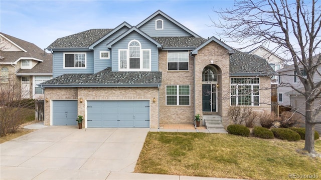 view of front of home with a front yard and a garage