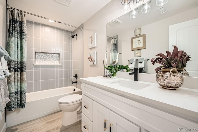 full bathroom with shower / bath combo with shower curtain, toilet, wood-type flooring, and vanity