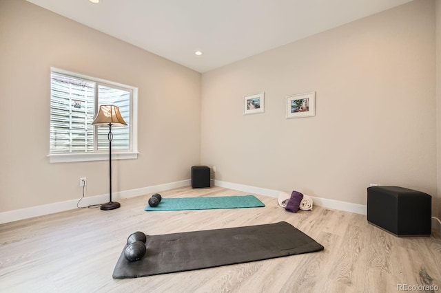 exercise room featuring light wood-type flooring