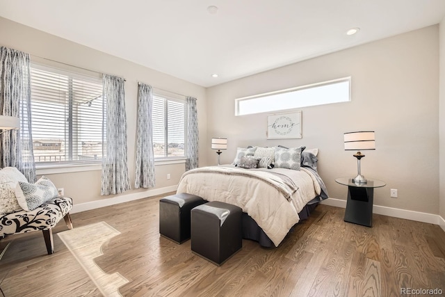 bedroom featuring hardwood / wood-style floors and multiple windows