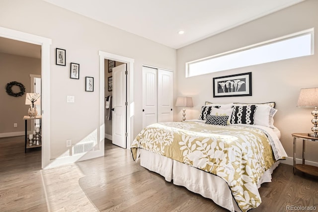 bedroom with hardwood / wood-style floors and a closet