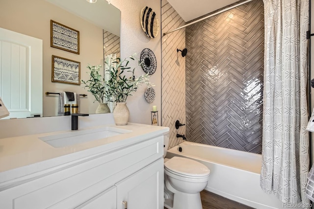 full bathroom featuring shower / tub combo, vanity, and toilet