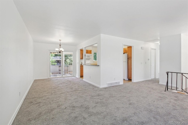 unfurnished living room with light carpet and a chandelier