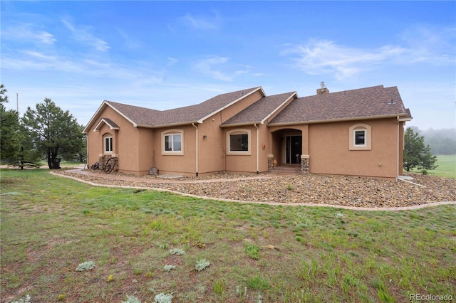 15910 Rhodes Pl, Elbert, CO 80106 - view of front of property featuring stucco siding, a front yard, and a chimney