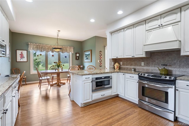15910 Rhodes Pl, Elbert, CO 80106 - kitchen with appliances with stainless steel finishes, custom exhaust hood, backsplash, a peninsula, and light wood-style flooring