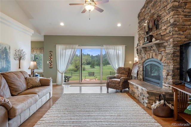 15910 Rhodes Pl, Elbert, CO 80106 - living area featuring a stone fireplace, lofted ceiling, ceiling fan, wood finished floors, and recessed lighting