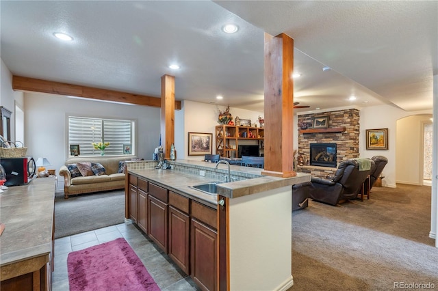 15910 Rhodes Pl, Elbert, CO 80106 - kitchen featuring open floor plan, a sink, a fireplace, a ceiling fan, and recessed lighting